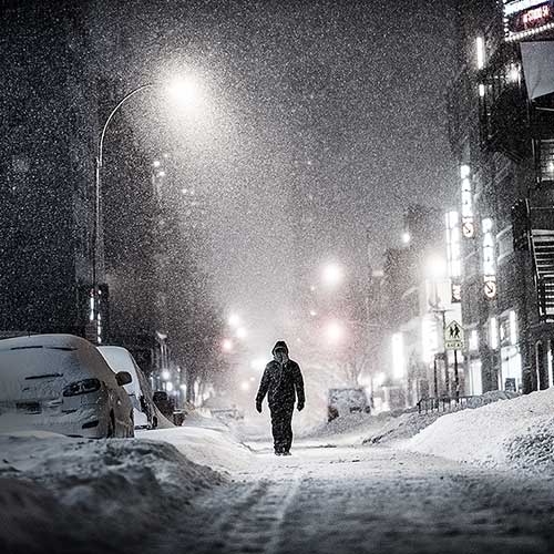 Thumbnail from A very high resolution VAST photo of a lonely person walking down an alley during the 2016 winter snow blizzard at night in New York City; created by Dan Piech